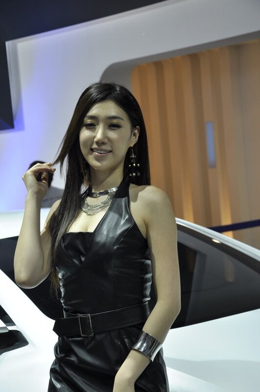 Woman in black dress at auto show