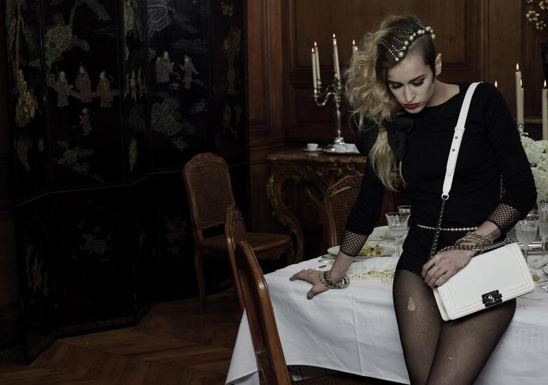 Woman in black dress at dinner table