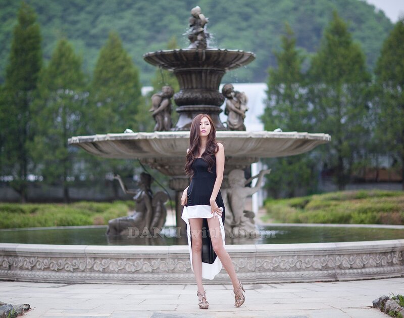 Woman in black dress at fountain