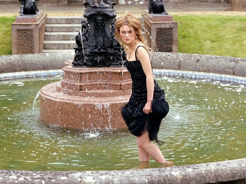 woman in black dress at fountain