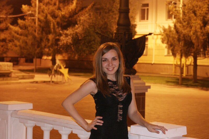 Woman in black dress at night