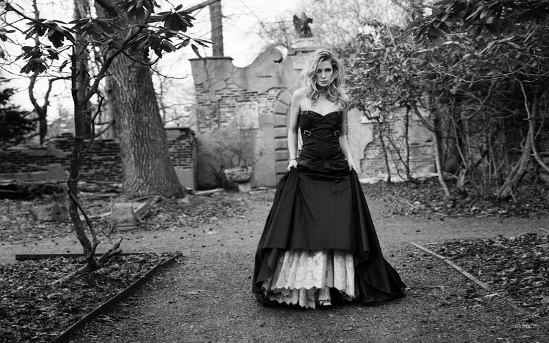 Woman in black dress at ruins