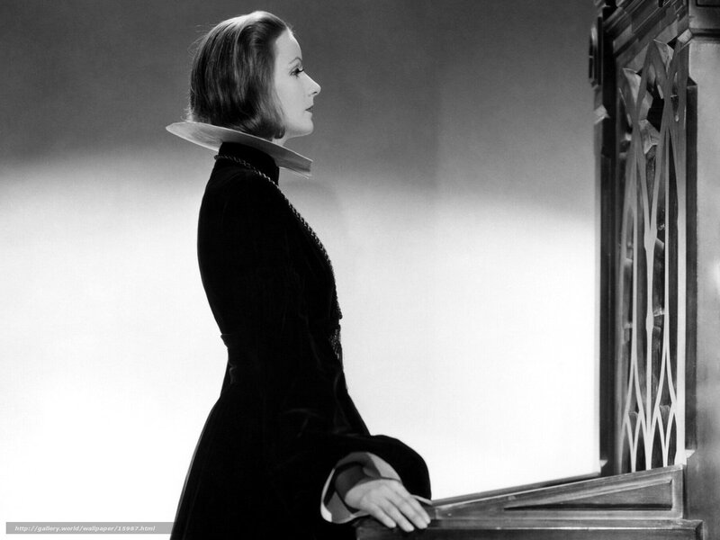 woman in black dress at window