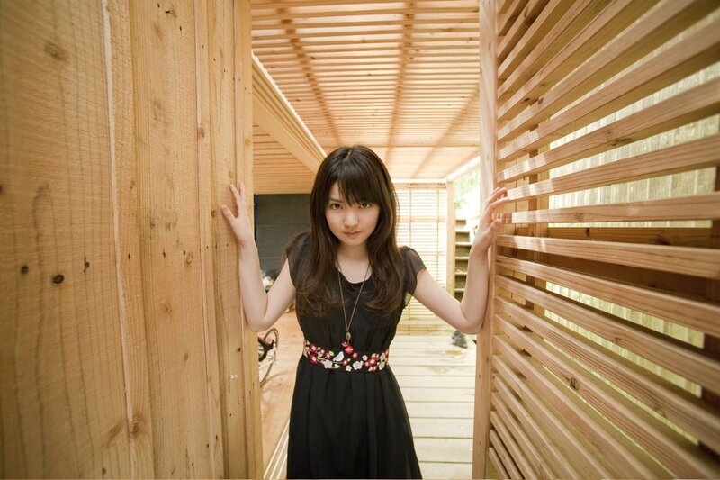 woman in black dress at wooden structure