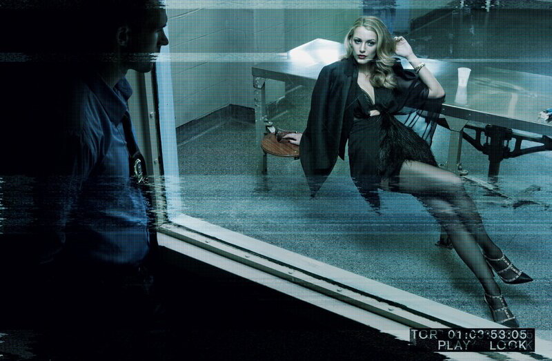 woman in black dress behind glass