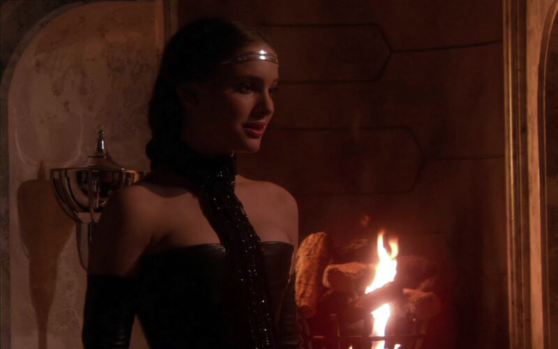 woman in black dress by fire