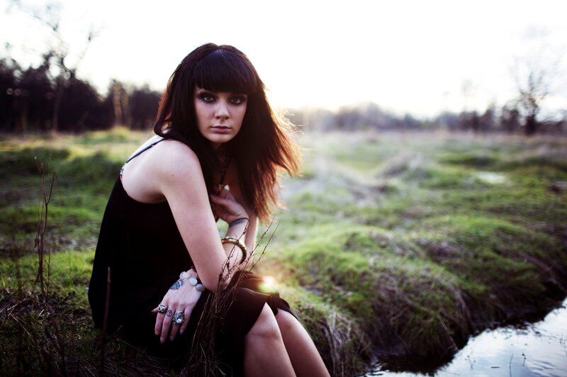 woman in black dress by stream
