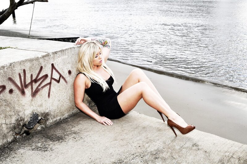 Woman in black dress by the water