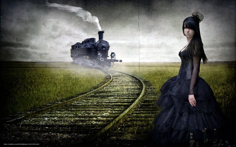 woman in black dress by train tracks