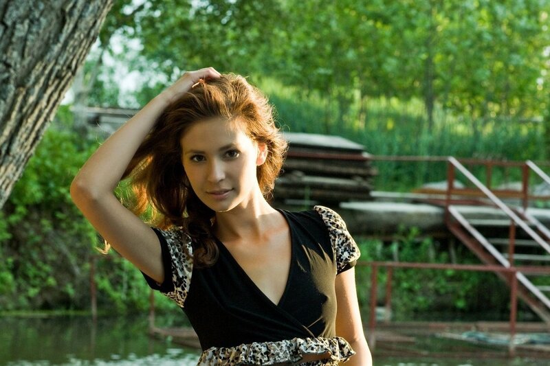 woman in black dress by water