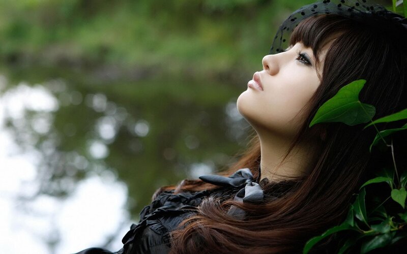 woman in black dress by water