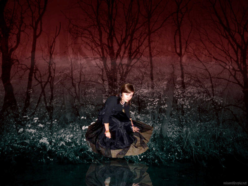 woman in black dress by water