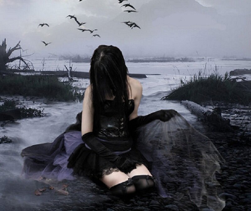 woman in black dress by water