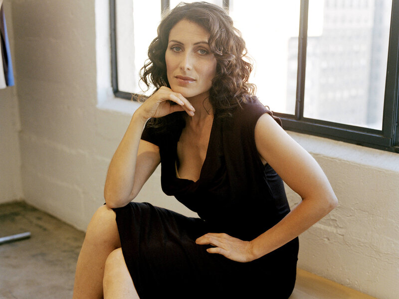 woman in black dress by window