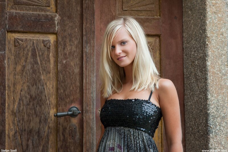 Woman in black dress by wooden door