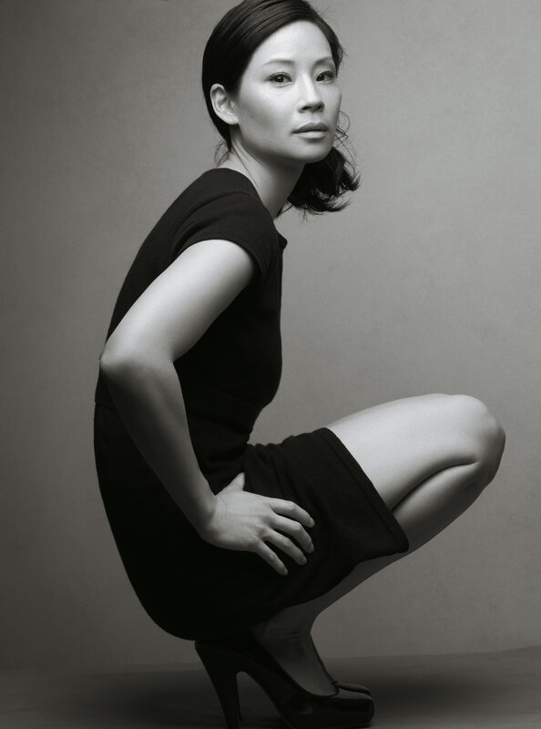 woman in black dress crouching