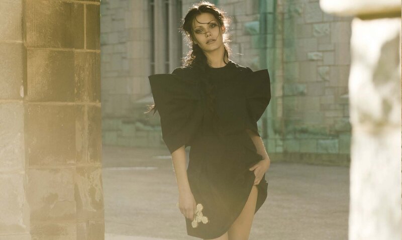 Woman in Black Dress — Dramatic, Afternoon, Photograph, Stone Wall