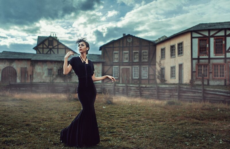 Woman in Black Dress — Dramatic, Photograph, Buildings