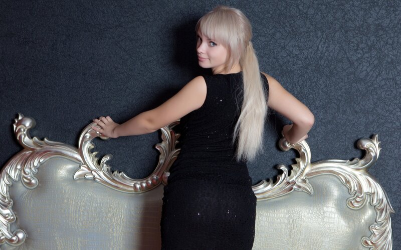 Woman in Black Dress — Dramatic, Photograph, Chair, Wall, Blonde Hair