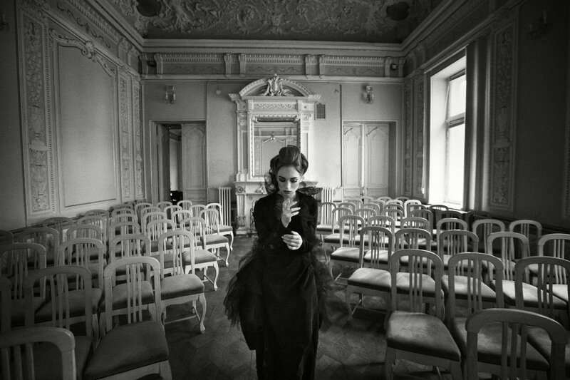 Woman in Black Dress — Dramatic, Photograph, Chairs