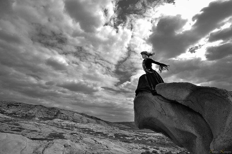 Woman in Black Dress — Dramatic, Photograph, Rock