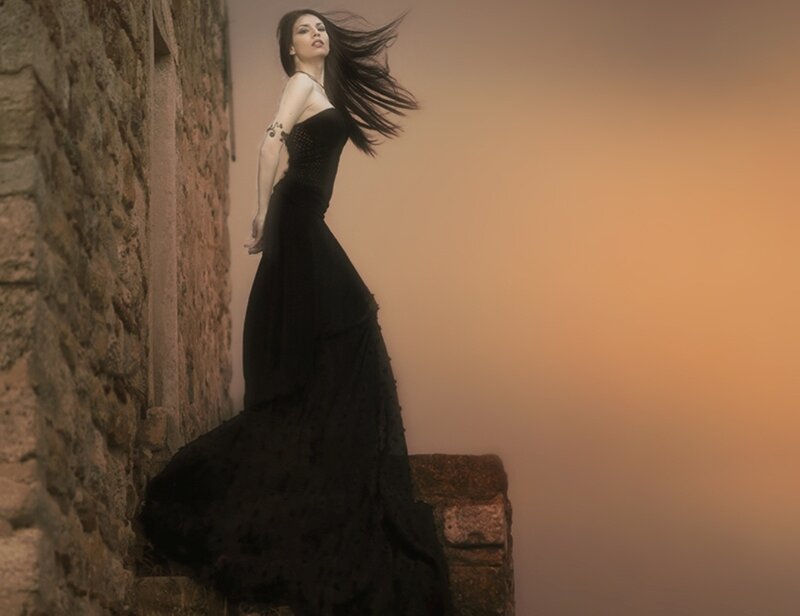 Woman in Black Dress — Dramatic, Sunset, Photograph, Stone Wall