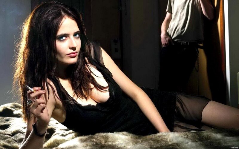 Woman in black dress holding cigarette