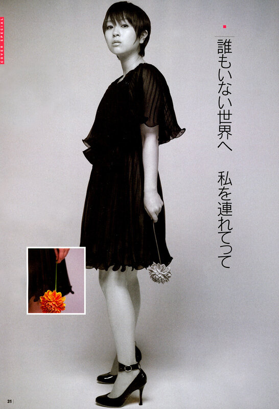 woman in black dress holding flower