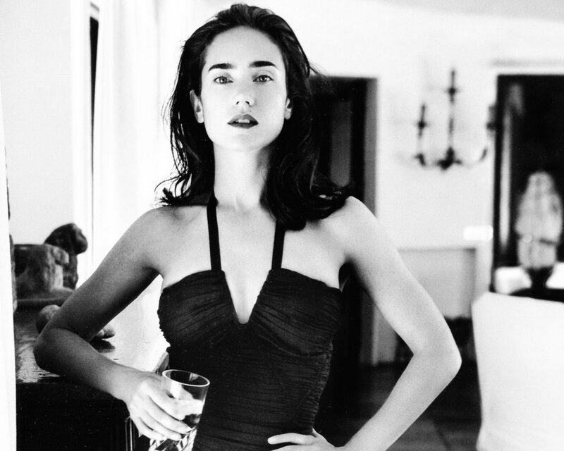 Woman in black dress holding glass