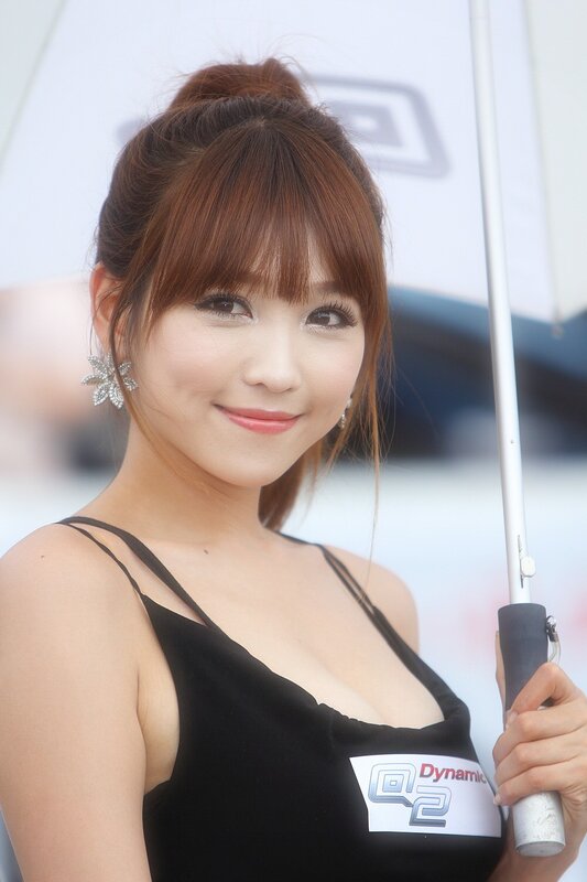 Woman in black dress holding umbrella