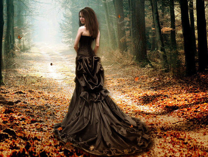 Woman in black dress in autumn forest