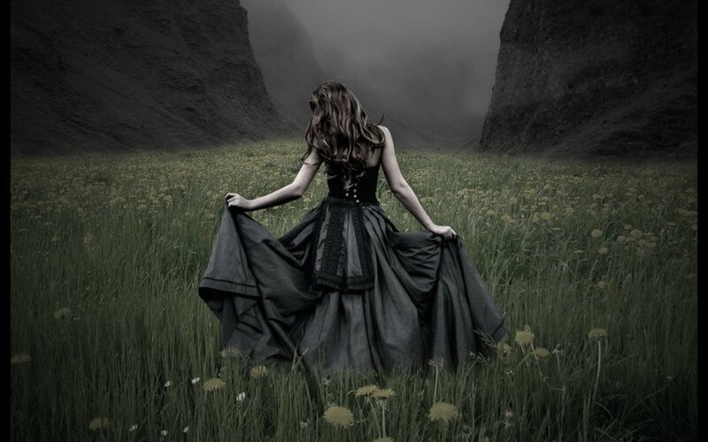 woman in black dress in field