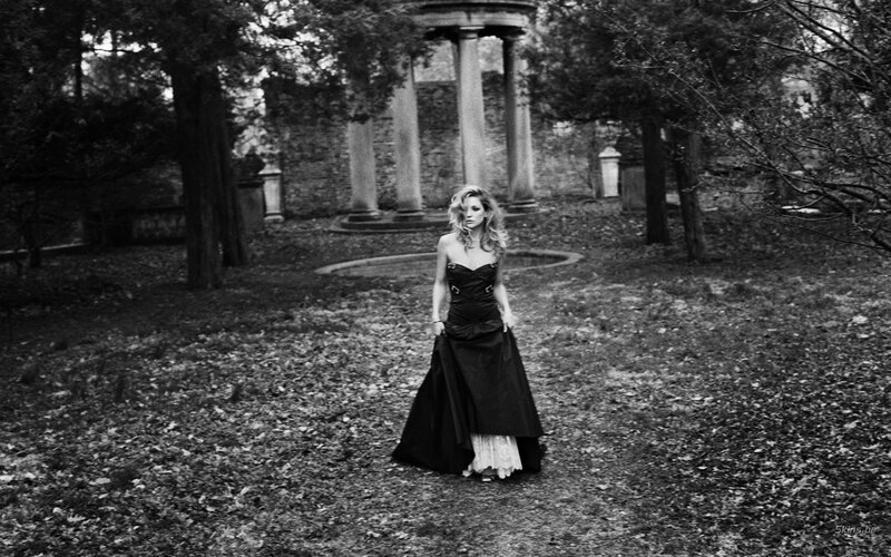 Woman in black dress in garden