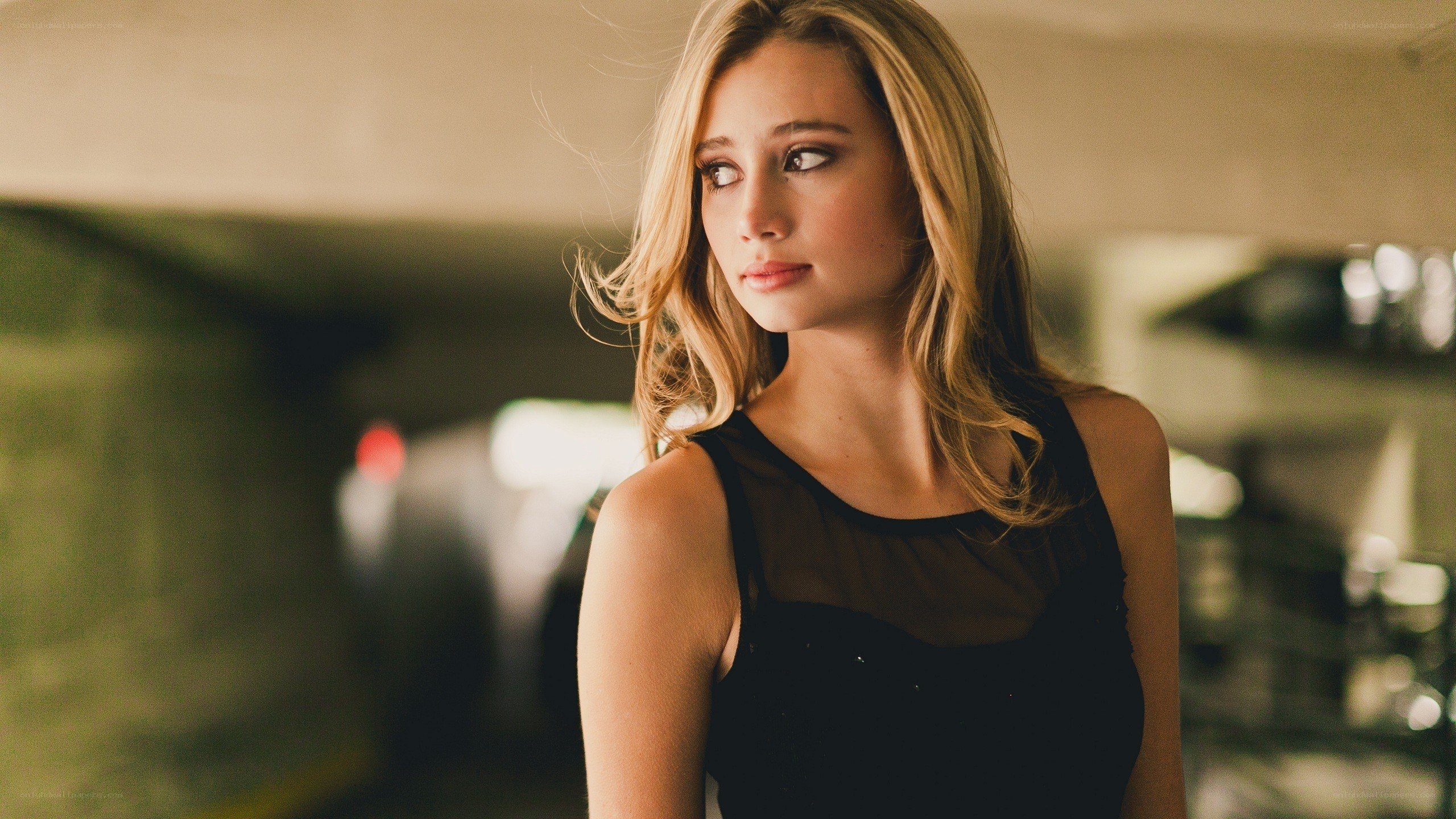 woman in black dress in parking garage