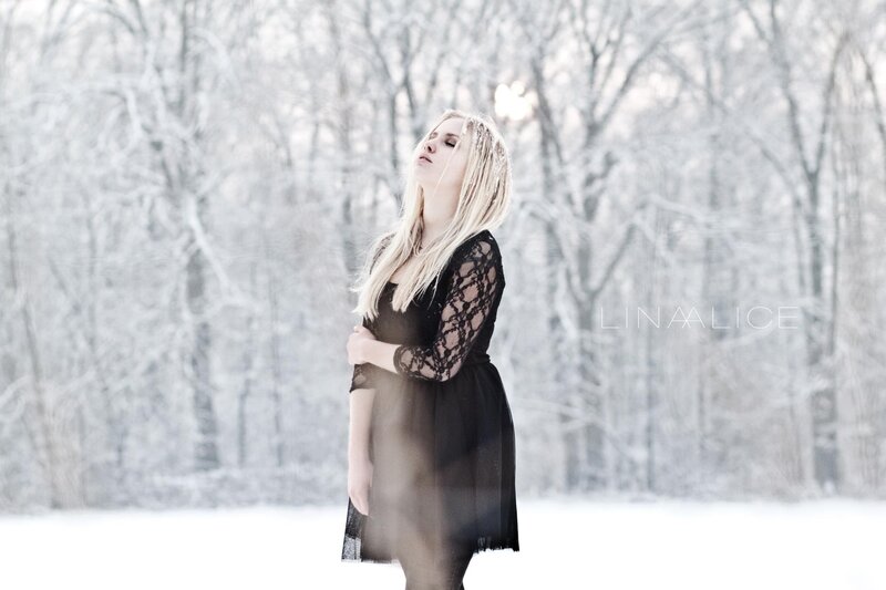 Woman in black dress in snow