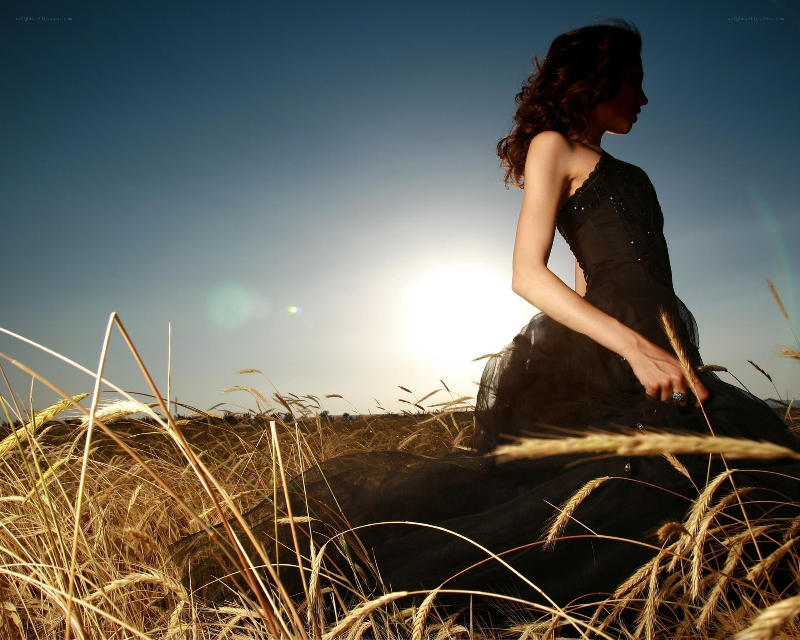 woman in black dress in wheat field