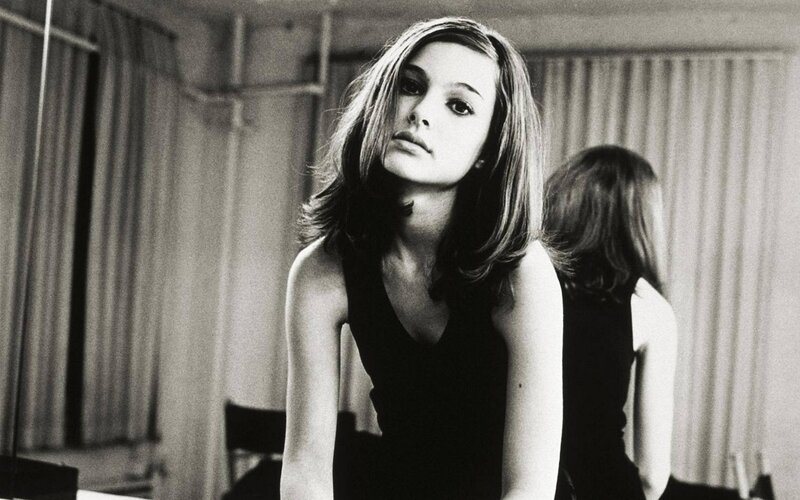 woman in black dress looking at camera