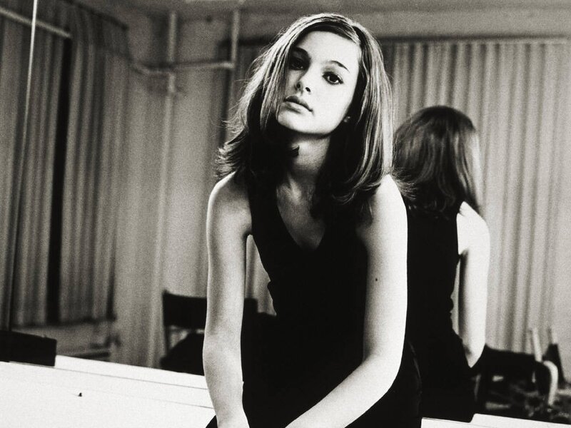 woman in black dress looking at camera