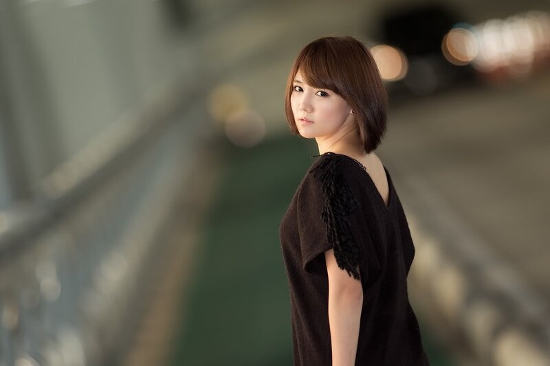 woman in black dress looking back