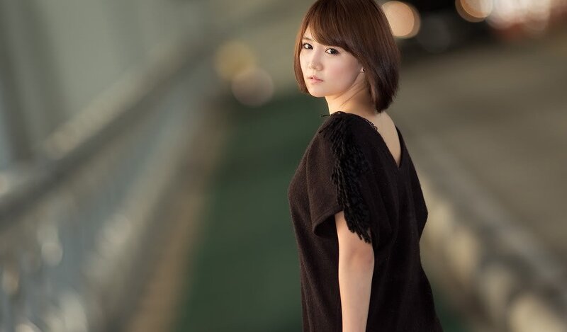 woman in black dress looking back