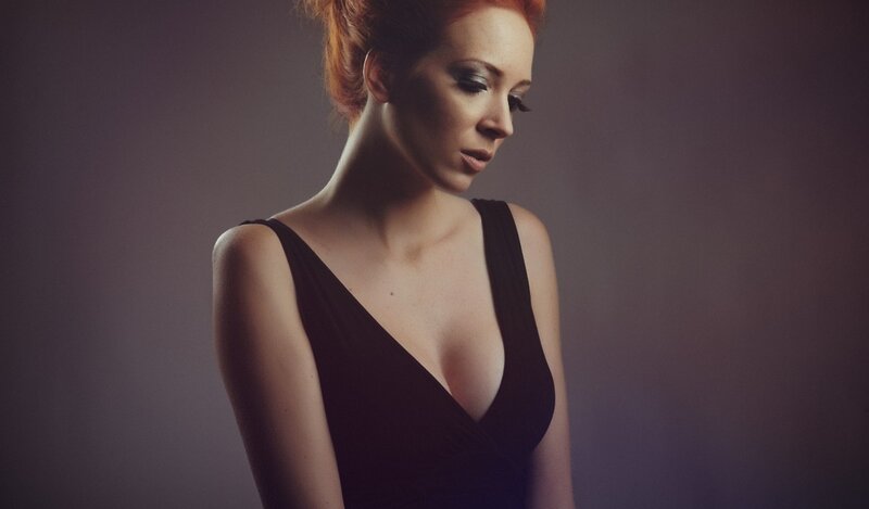 woman in black dress looking down