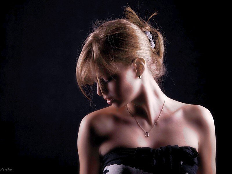 woman in black dress looking down