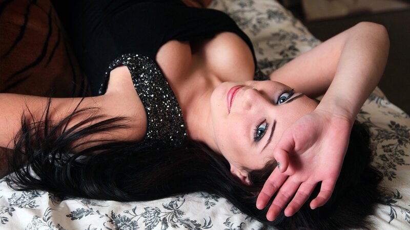 woman in black dress lying down