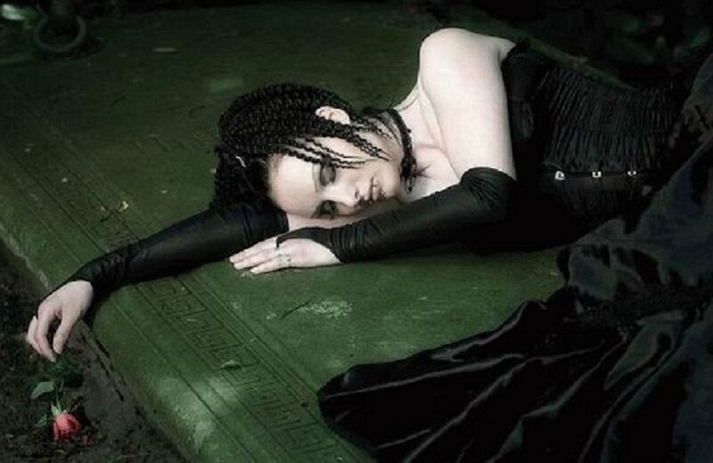 woman in black dress lying down