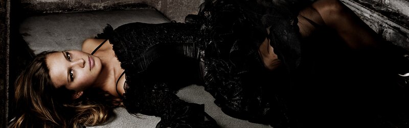 woman in black dress lying down
