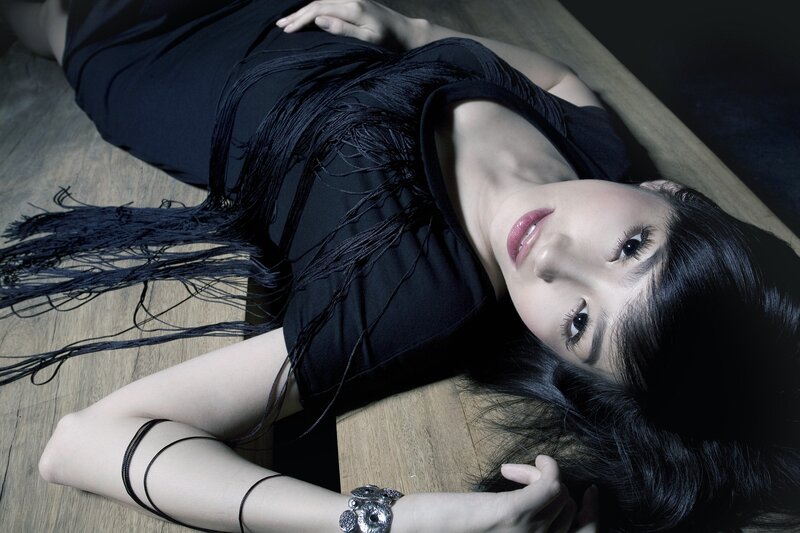 woman in black dress lying down