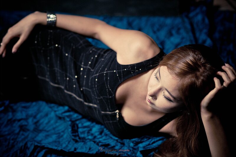 woman in black dress lying down