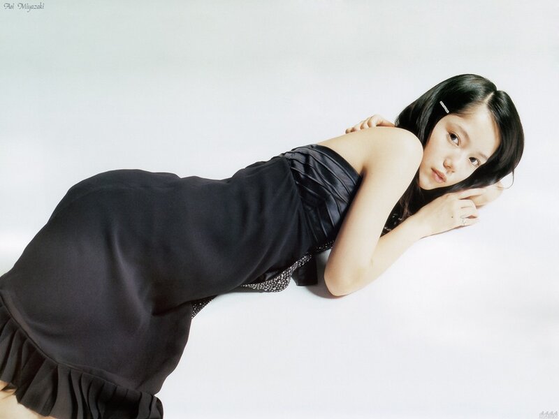 Woman in black dress lying down