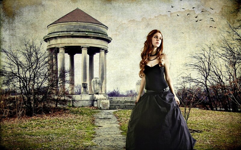 Woman in black dress near gazebo