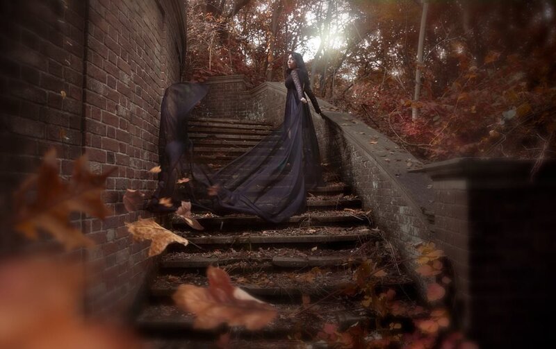 Woman in black dress on autumn stairs